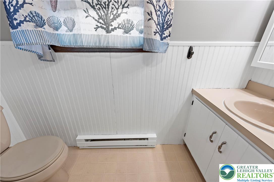 3006 Beddall Street Slatington, PA 18080 - Photo 13 of 31 a bathroom with a granite countertop sink a toilet and a mirror