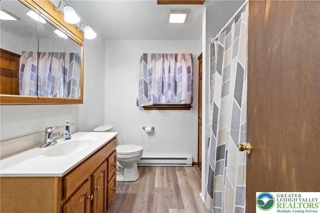 3006 Beddall Street Slatington, PA 18080 - Photo 22 of 31 a bathroom with a sink a toilet and a shower curtain