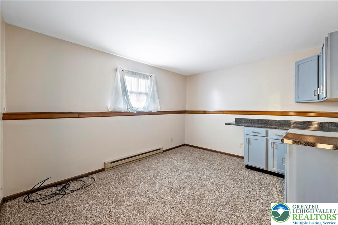 3006 Beddall Street Slatington, PA 18080 - Photo 23 of 31 a kitchen with granite countertop white cabinets and white appliances