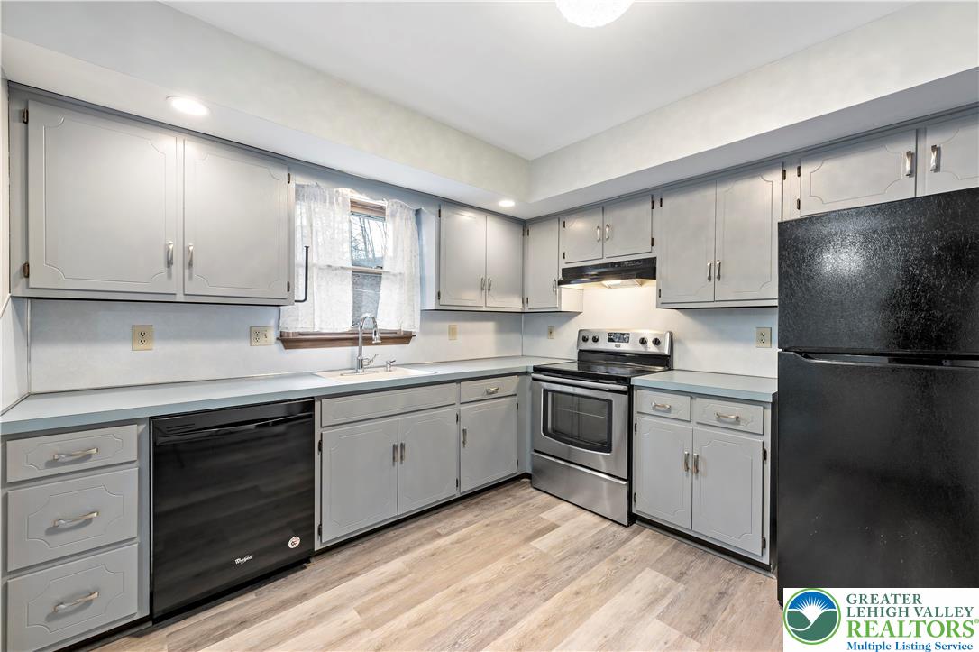 3006 Beddall Street Slatington, PA 18080 - Photo 9 of 31 a kitchen with a sink a refrigerator and cabinets