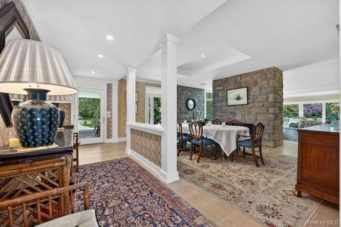 343 Chicken Valley Road Glen Head, NY 11545 - Photo 49 of 49 a living room with furniture a fireplace and a chandelier