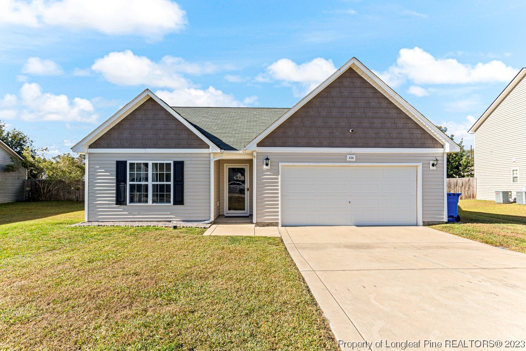 634 Broad Drive Raeford, NC 28376 - Photo 1 of 31 a front view of a house with a garden and yard
