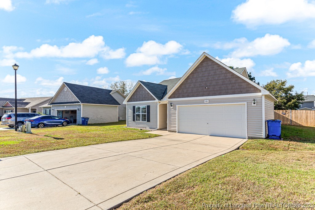 634 Broad Drive Raeford, NC 28376 - Photo 2 of 31 a yellow house with trees in front of it