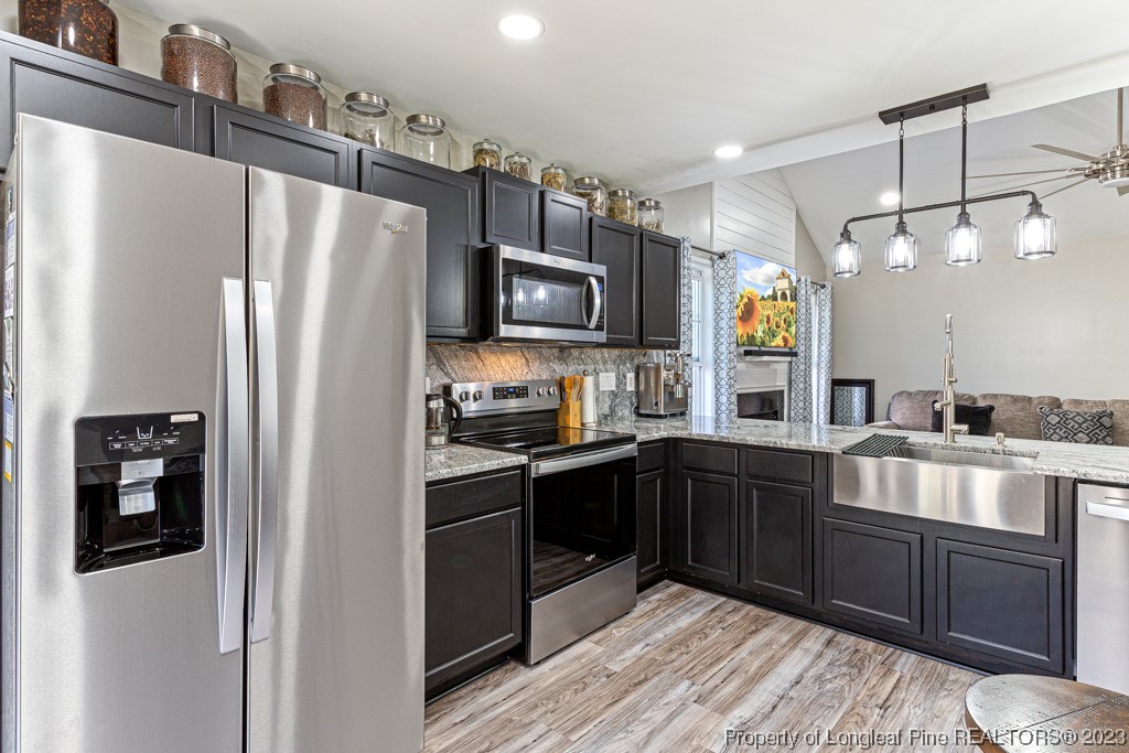 634 Broad Drive Raeford, NC 28376 - Photo 21 of 31 a kitchen with stainless steel appliances a refrigerator sink and stove