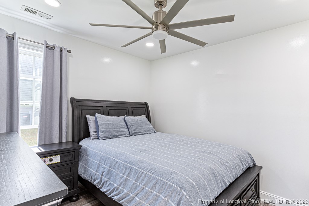 634 Broad Drive Raeford, NC 28376 - Photo 26 of 31 a bedroom with a bed and a ceiling fan