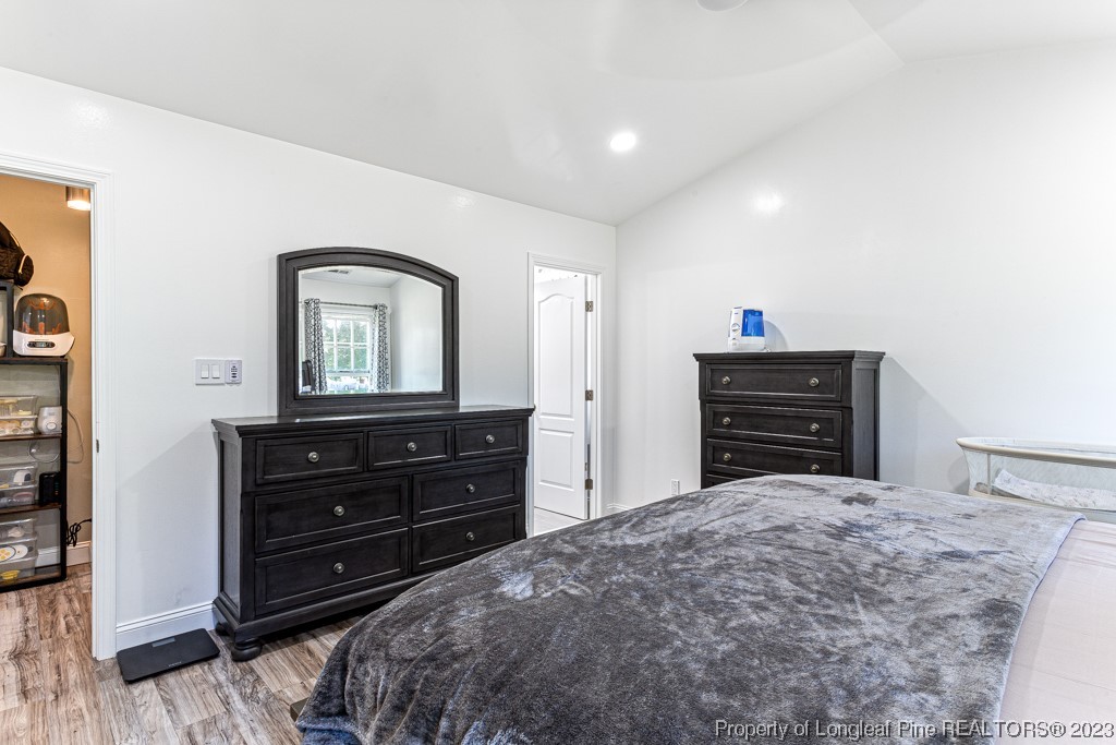 634 Broad Drive Raeford, NC 28376 - Photo 29 of 31 a bedroom with a bed and a mirror on dresser