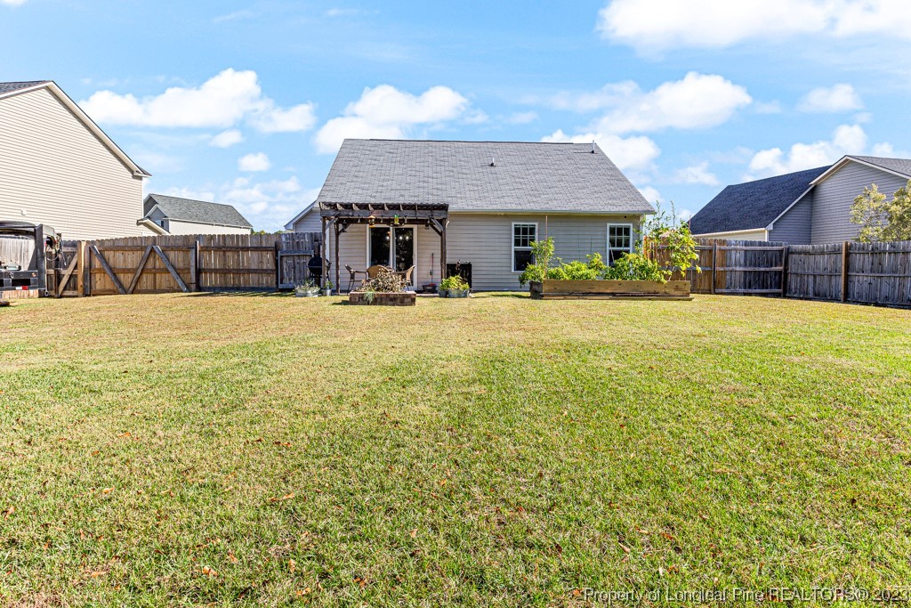 634 Broad Drive Raeford, NC 28376 - Photo 7 of 31 a front view of house with yard and trees in the background