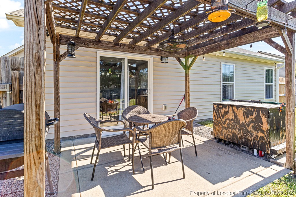 634 Broad Drive Raeford, NC 28376 - Photo 10 of 31 a patio with table and chairs and potted plants