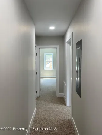 a view of hallway with bathroom