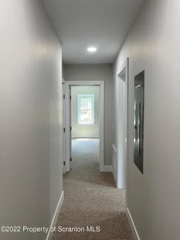 a view of hallway with bathroom