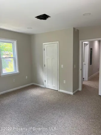 a view of an empty room with a window