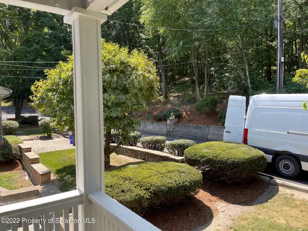 a view of a patio with table and chairs with wooden floor and fence
