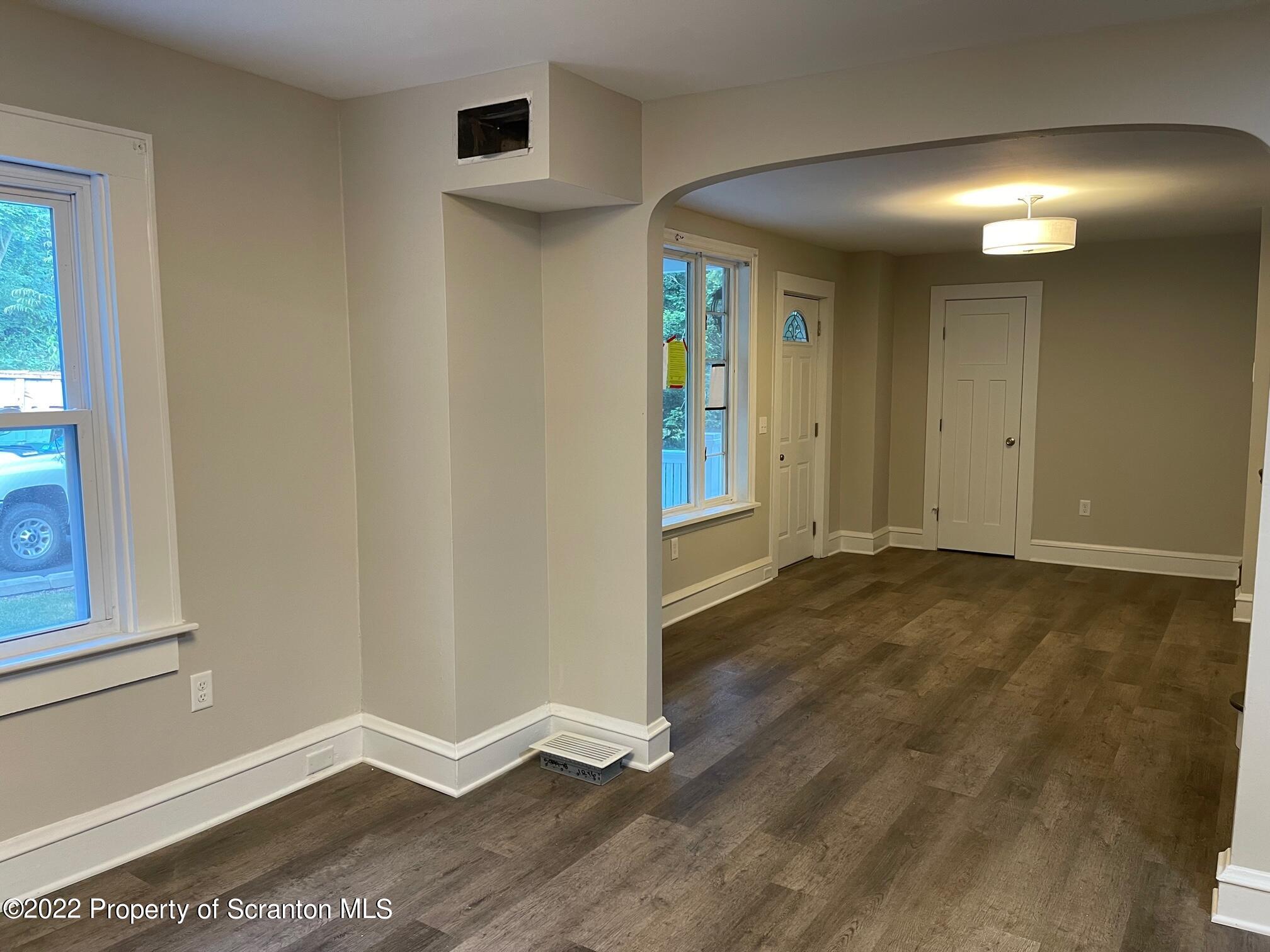 1833 South Webster Avenue Scranton, PA 18505 - Photo 9 of 17 an empty room with wooden floor and windows