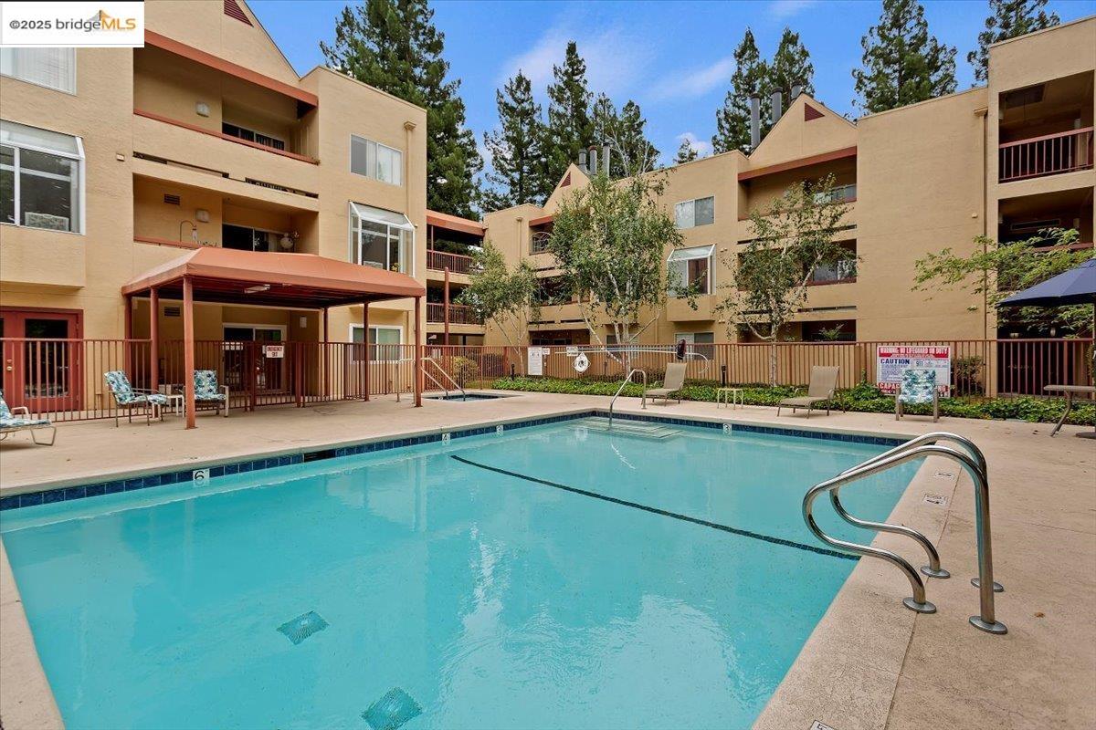 1308 Walden Road, Unit 32 Walnut Creek, CA 94597 - Photo 14 of 43 a swimming pool with outdoor seating and yard