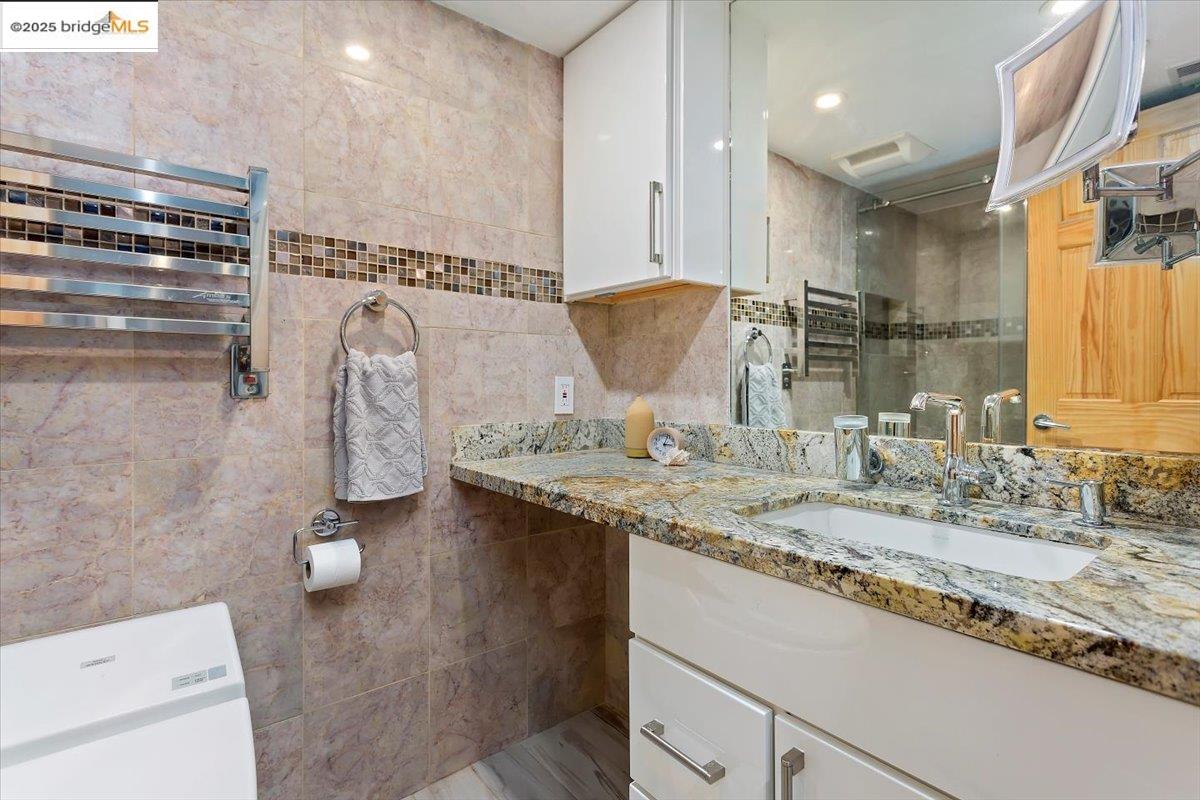 1308 Walden Road, Unit 32 Walnut Creek, CA 94597 - Photo 21 of 43 a bathroom with a granite countertop sink and a mirror