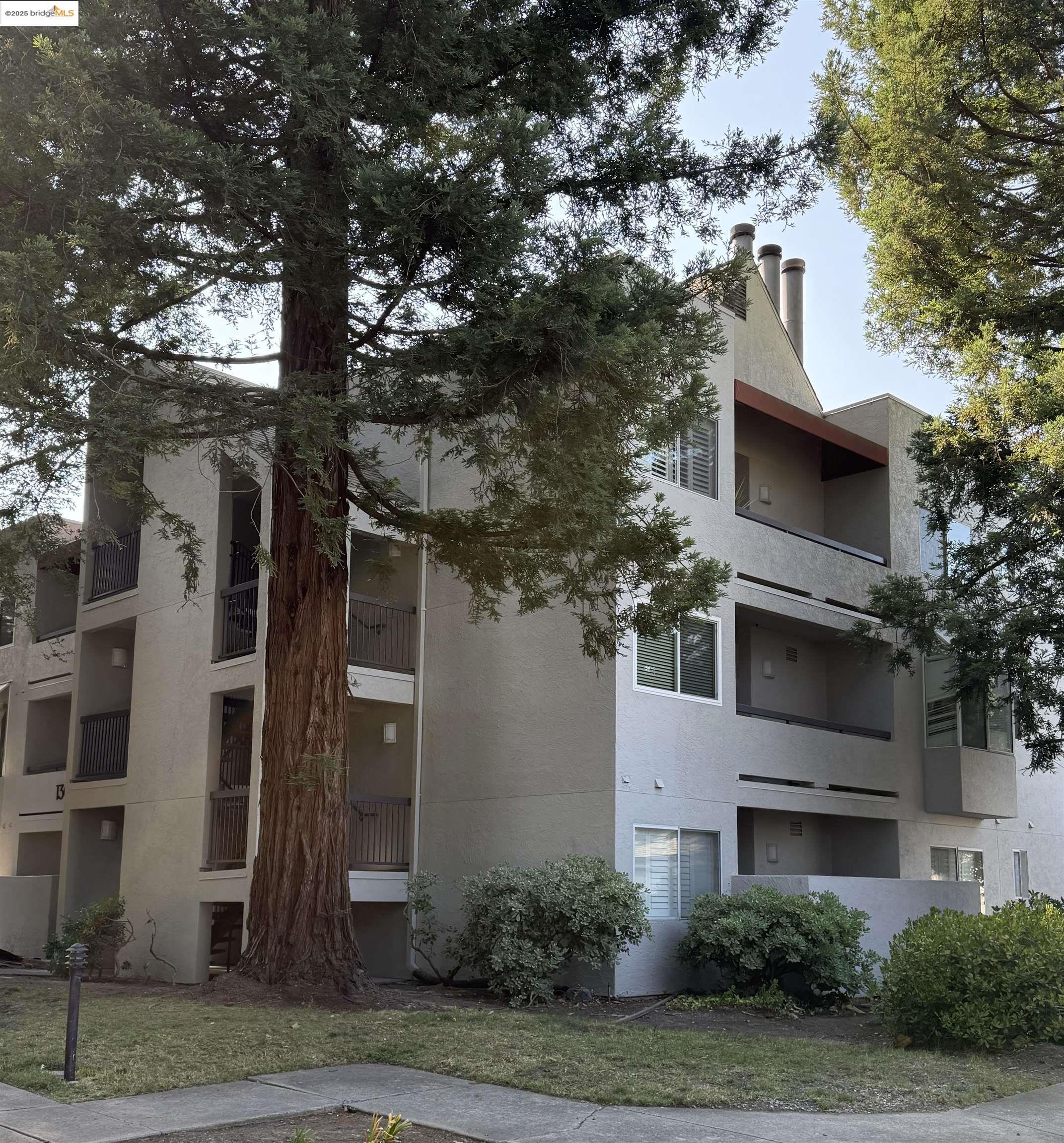 1308 Walden Road, Unit 32 Walnut Creek, CA 94597 - Photo 39 of 43 a front view of a house with a yard and garage