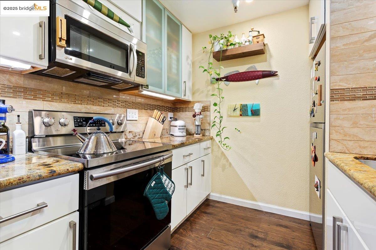 1308 Walden Road, Unit 32 Walnut Creek, CA 94597 - Photo 7 of 43 a kitchen with stainless steel appliances granite countertop a stove and a microwave