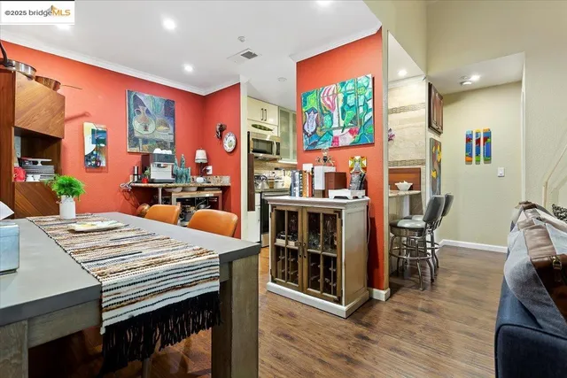 a large dining space with furniture window and wooden floor