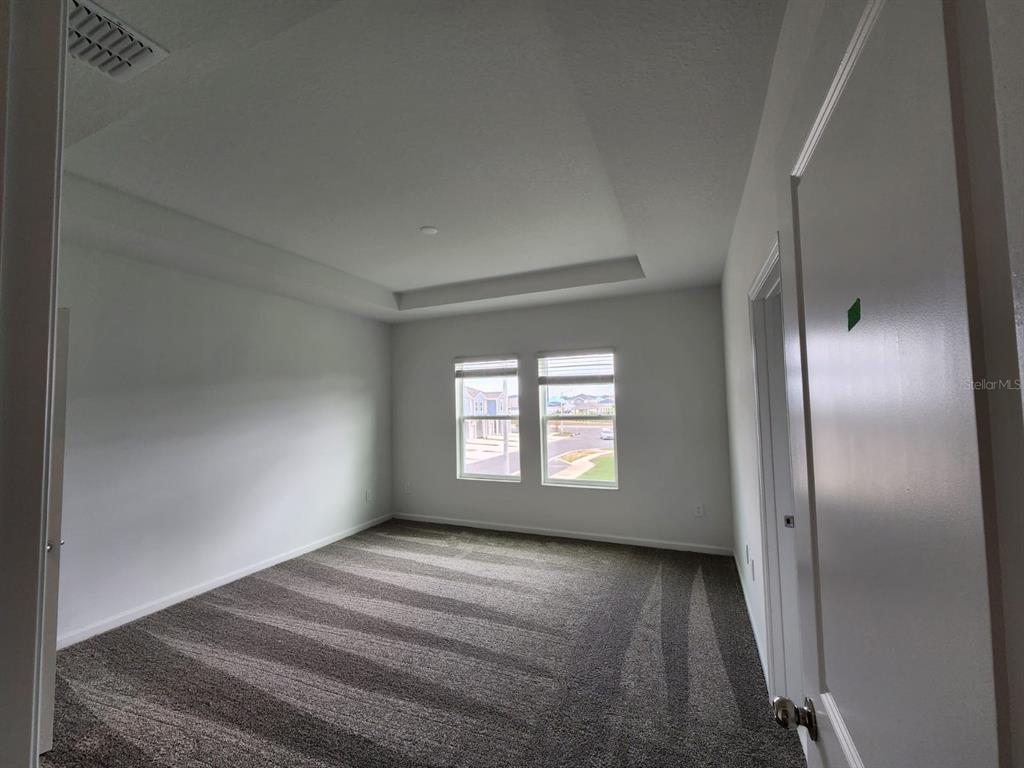 3258 Laurent Loop Davenport, FL 33837 - Photo 15 of 26 an empty room with windows