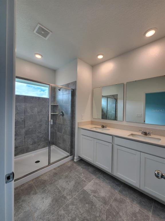 3258 Laurent Loop Davenport, FL 33837 - Photo 17 of 26 a bathroom with a bathtub and a sink