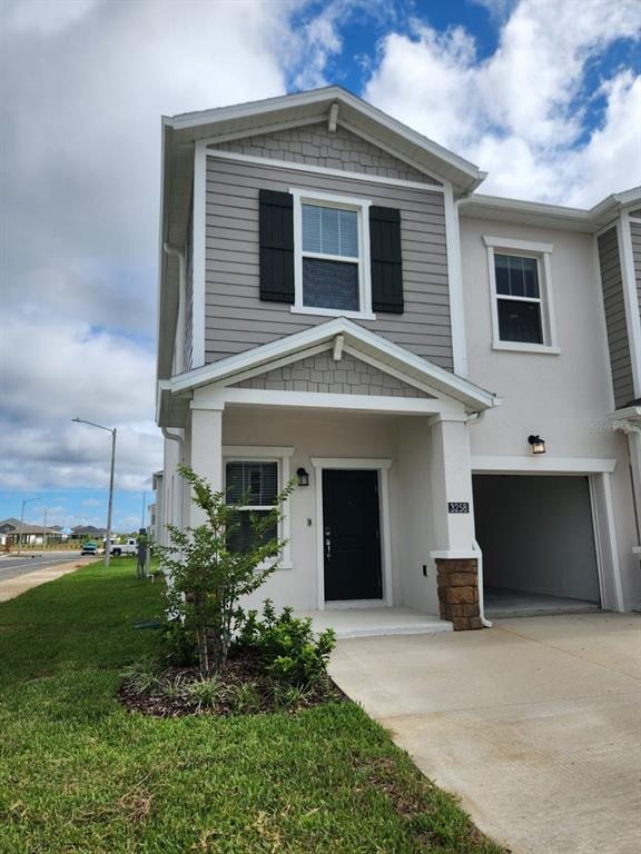3258 Laurent Loop Davenport, FL 33837 - Photo 21 of 26 a front view of a house with a yard and garage