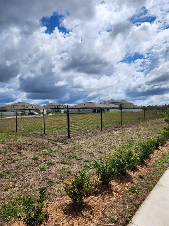 3258 Laurent Loop Davenport, FL 33837 - Photo 23 of 26 a view of a yard with a lake