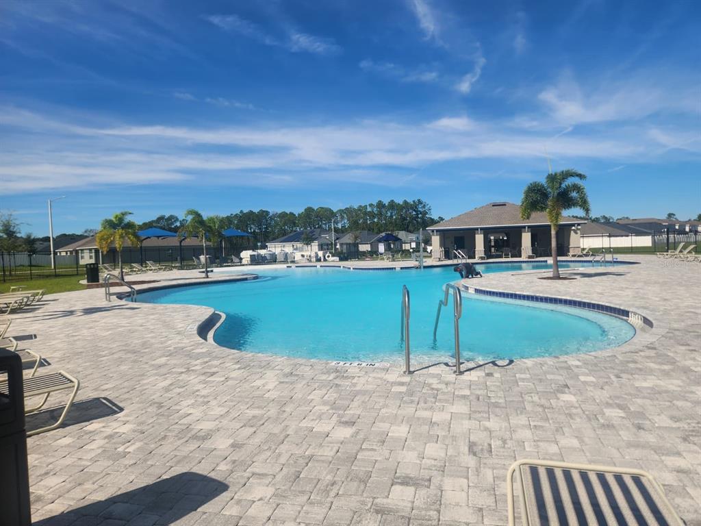 3258 Laurent Loop Davenport, FL 33837 - Photo 26 of 26 a view of a swimming pool and an chairs