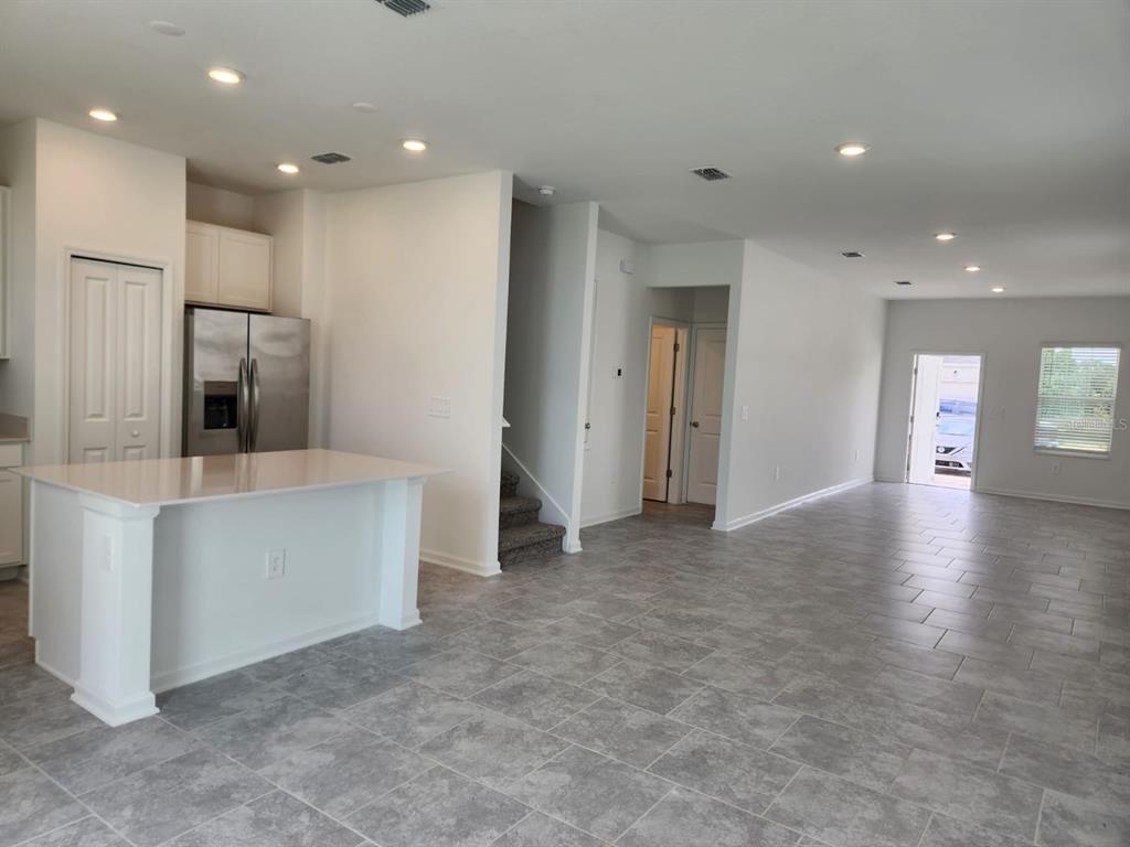 3258 Laurent Loop Davenport, FL 33837 - Photo 6 of 26 a view of an empty room with kitchen and window
