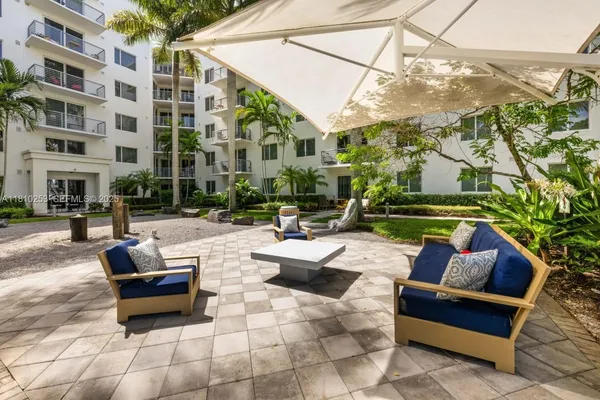 a view of a patio with couches and a fire pit