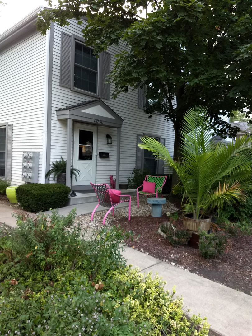 1675 Valley Forge Court, Unit E Wheaton, IL 60189 - Photo 2 of 11 a view of a house with backyard and sitting area