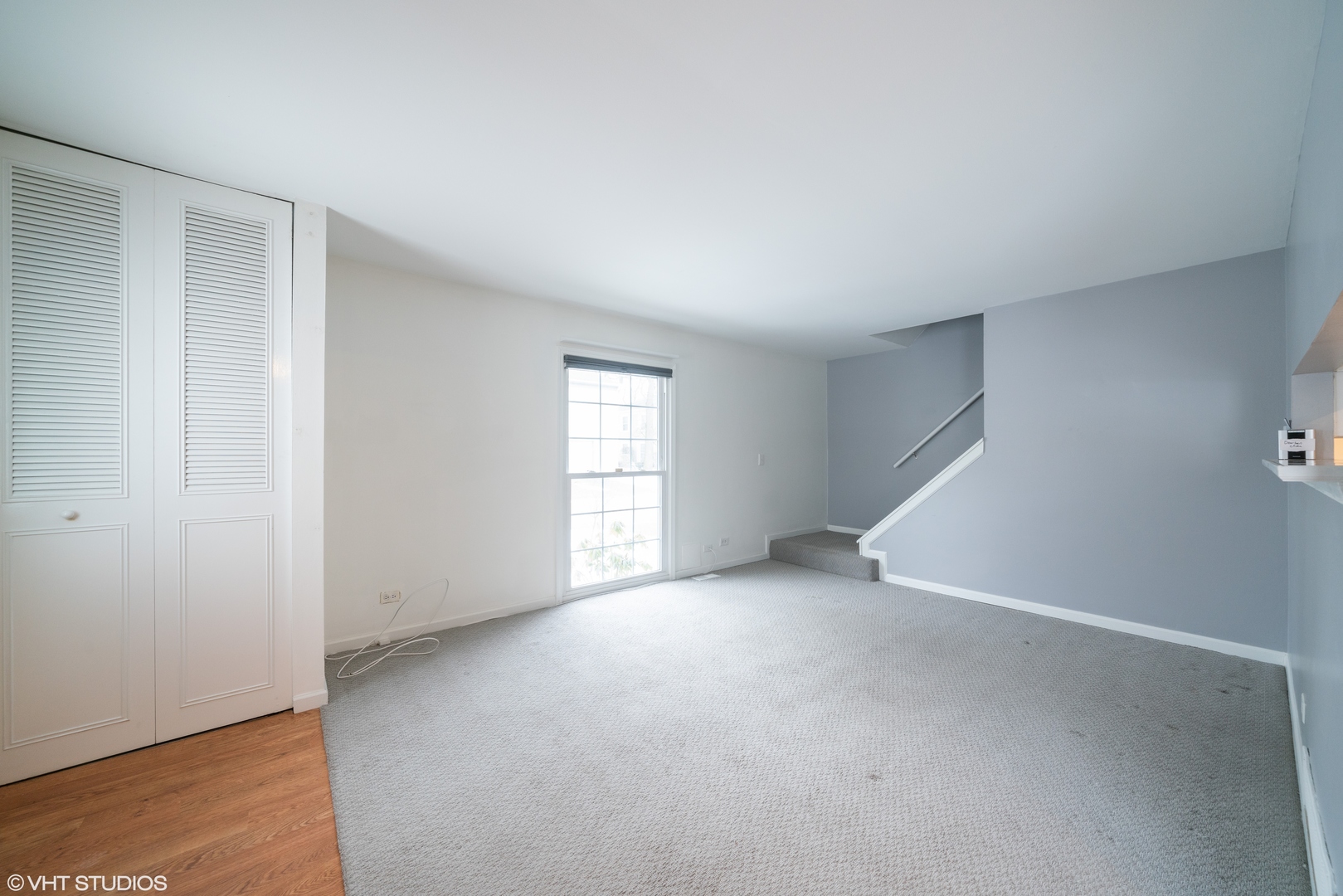 1675 Valley Forge Court, Unit E Wheaton, IL 60189 - Photo 4 of 11 an empty room with windows
