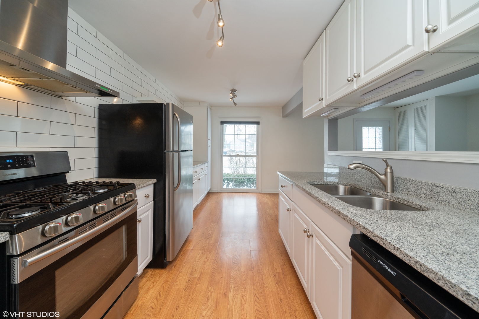 1675 Valley Forge Court, Unit E Wheaton, IL 60189 - Photo 6 of 11 a kitchen with stainless steel appliances granite countertop a sink stove and refrigerator