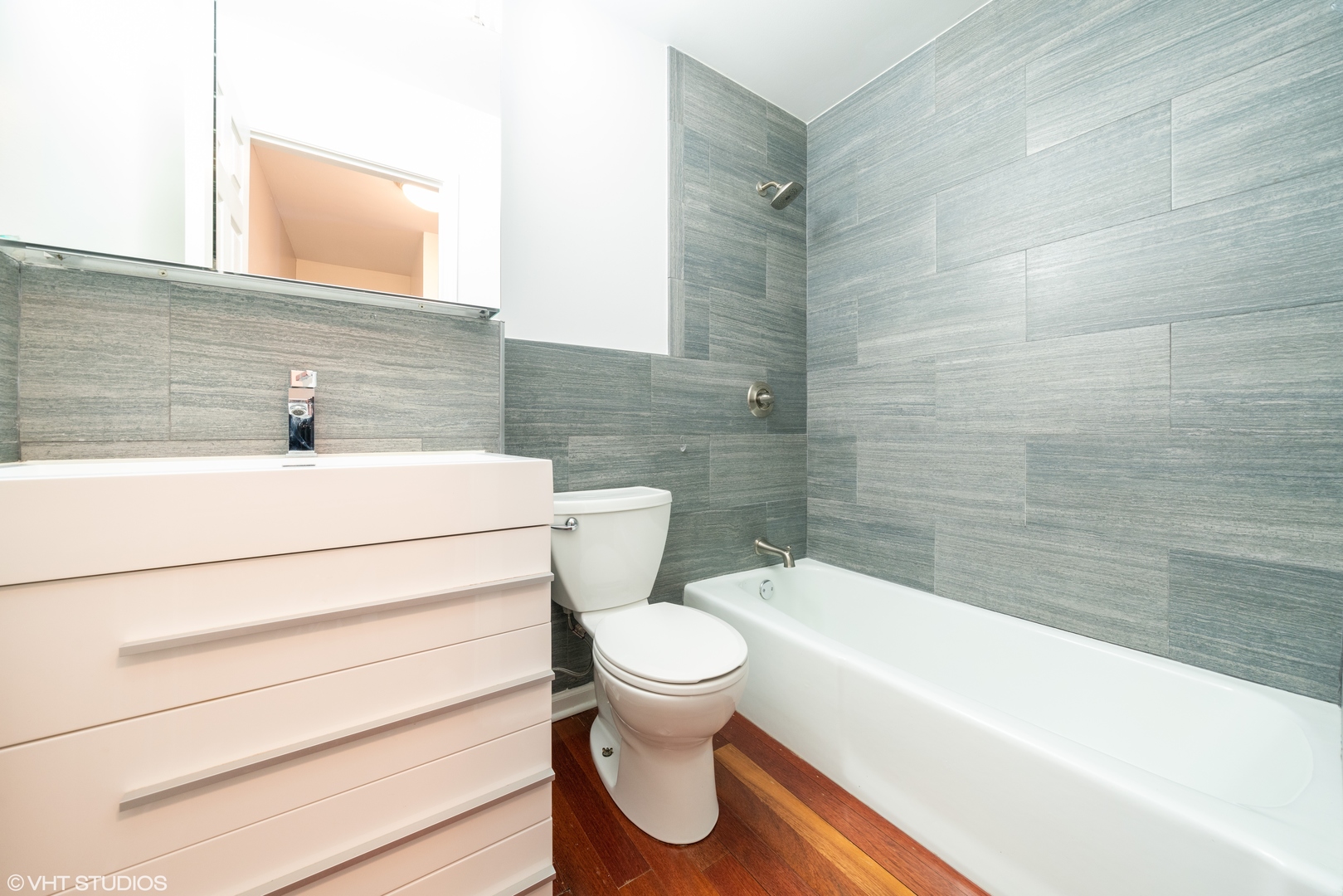 1675 Valley Forge Court, Unit E Wheaton, IL 60189 - Photo 7 of 11 a bathroom with a toilet and a bathtub