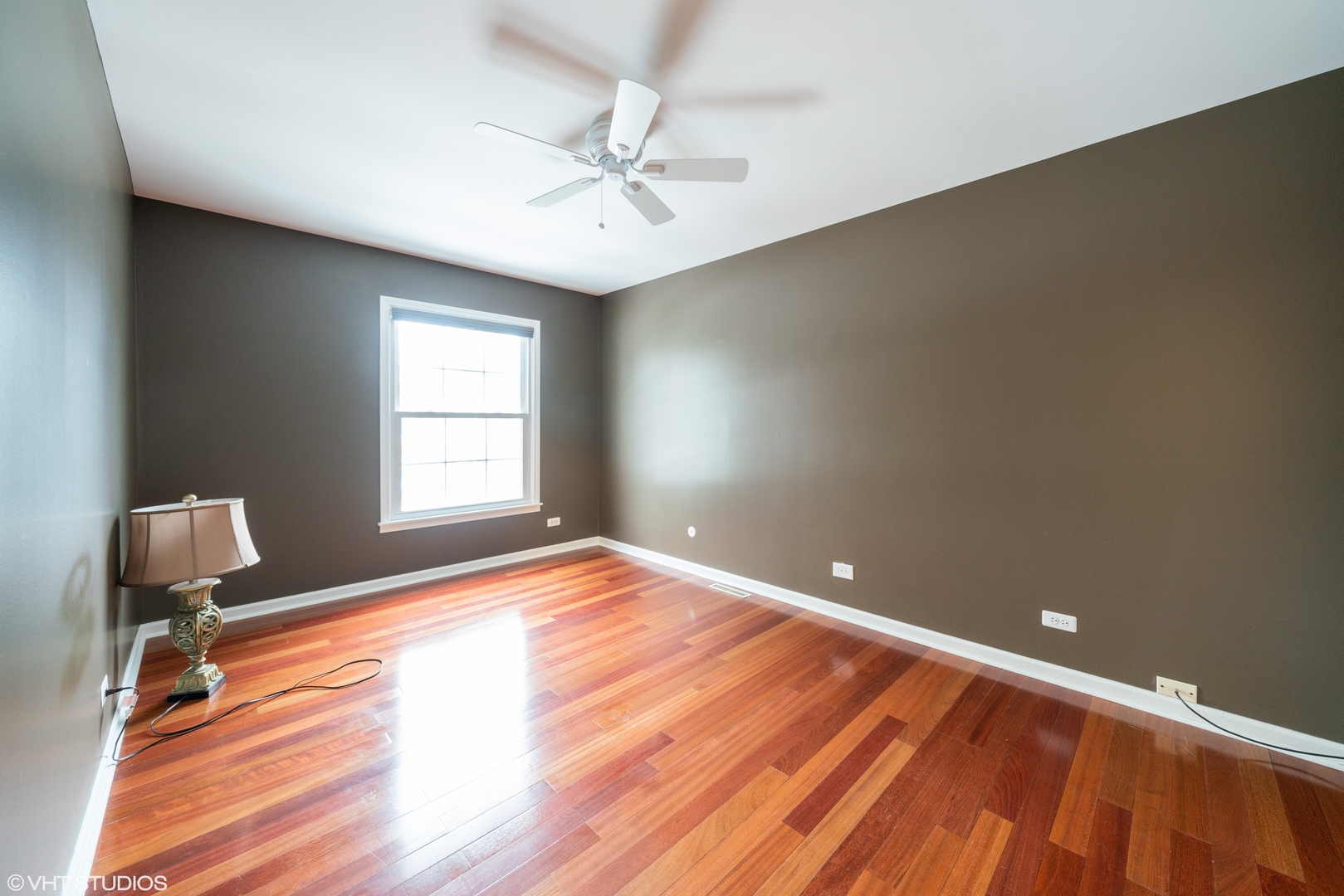 1675 Valley Forge Court, Unit E Wheaton, IL 60189 - Photo 8 of 11 a view of empty room with wooden floor and fan