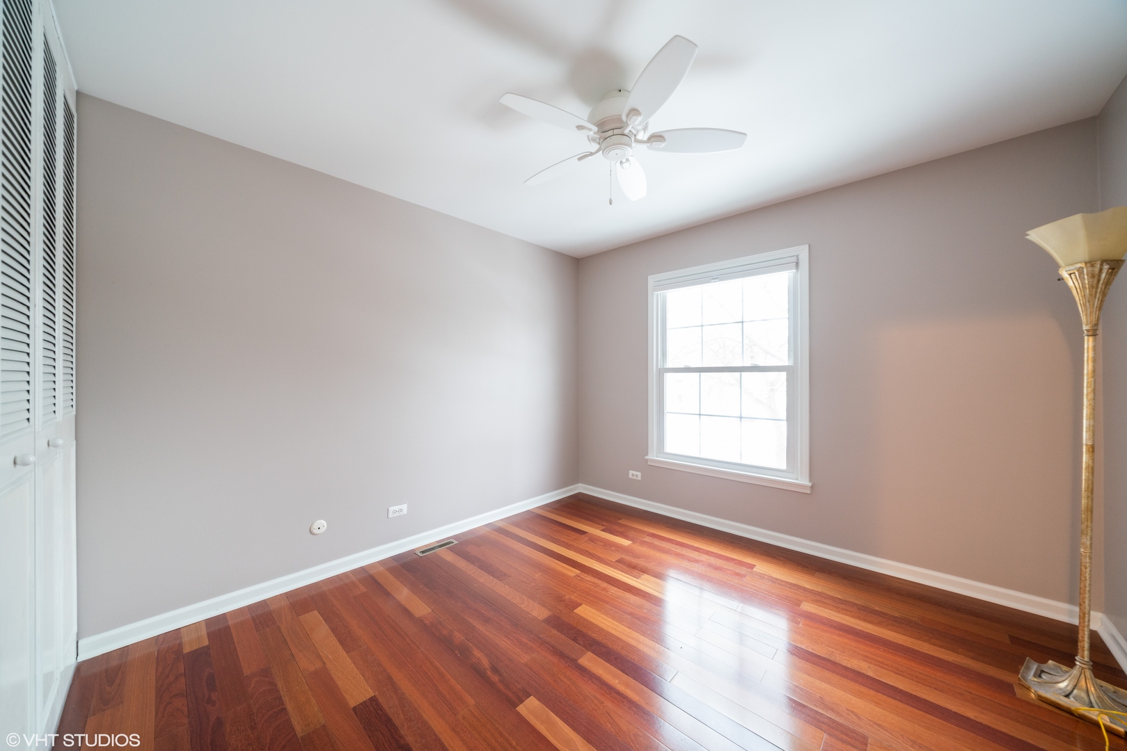 1675 Valley Forge Court, Unit E Wheaton, IL 60189 - Photo 9 of 11 wooden floor in an empty room with a window