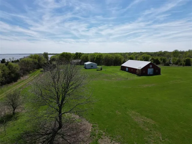 a view of a field of grass and trees