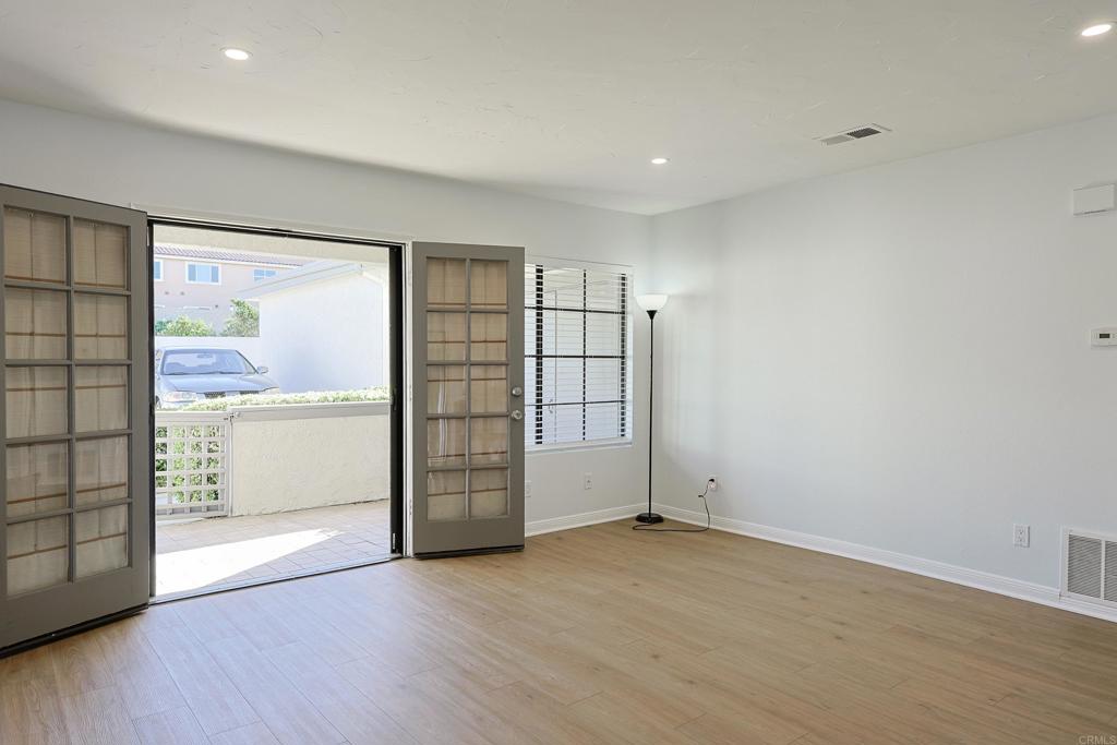 8612 Arminda Circle, Unit 51 Santee, CA 92071 - Photo 21 of 55 an empty room with wooden floor and windows