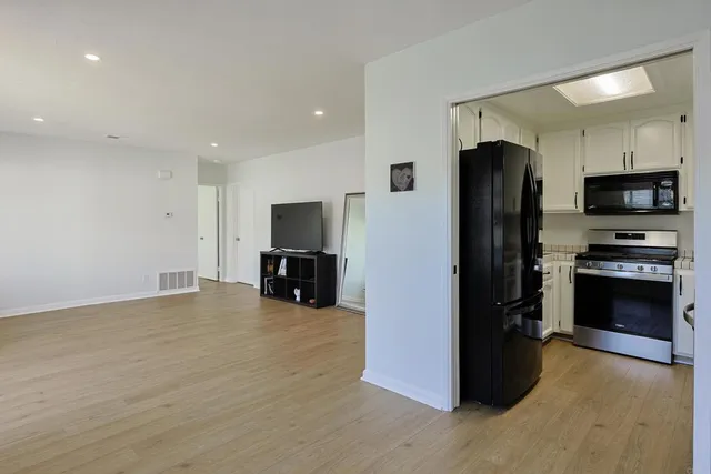 a kitchen with stainless steel appliances a stove sink and refrigerator