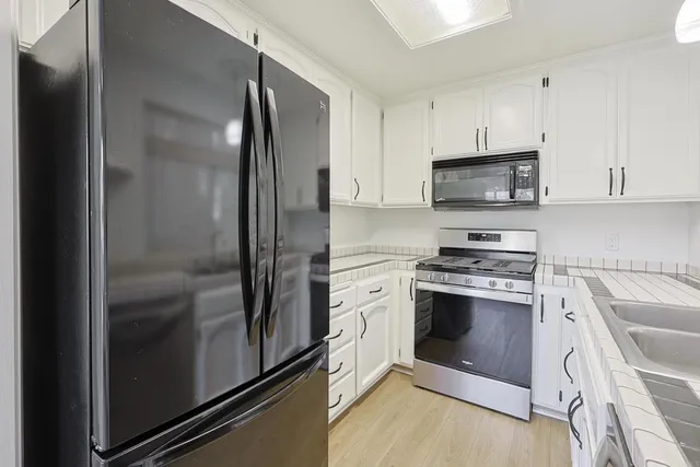 a kitchen with a sink and chandelier