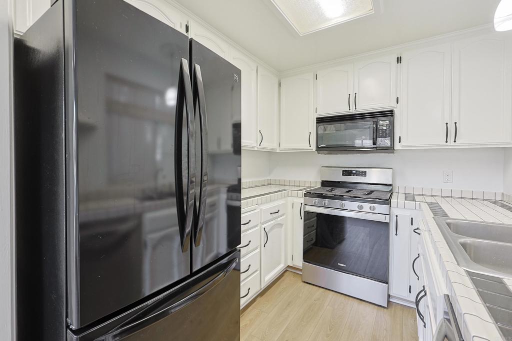 8612 Arminda Circle, Unit 51 Santee, CA 92071 - Photo 26 of 55 a kitchen with stainless steel appliances a stove sink and refrigerator