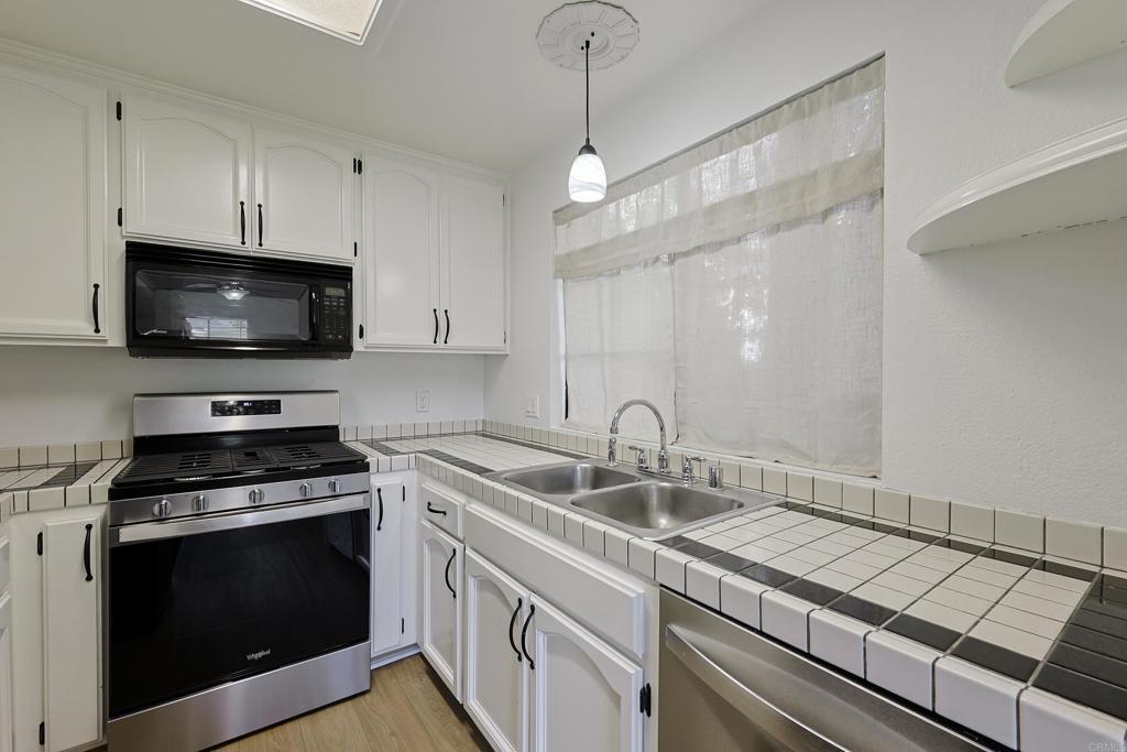 8612 Arminda Circle, Unit 51 Santee, CA 92071 - Photo 27 of 55 a kitchen with a sink stove and microwave