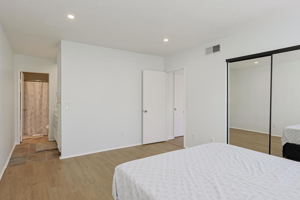 8612 Arminda Circle, Unit 51 Santee, CA 92071 - Photo 33 of 55 a bedroom with a bed and a mirror