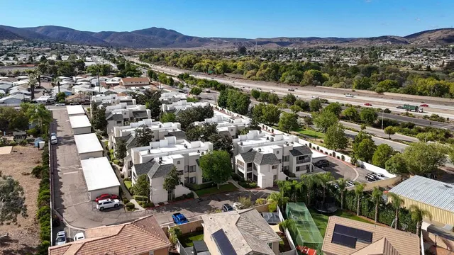an aerial view of residential houses with outdoor space and river