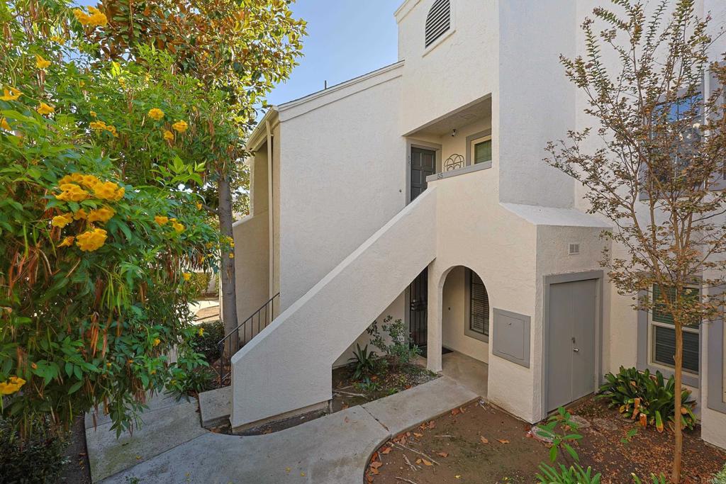 8612 Arminda Circle, Unit 51 Santee, CA 92071 - Photo 44 of 55 a view of a white house with a yard and large tree
