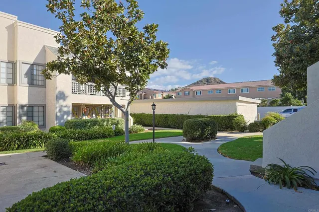 a view of building with car parked