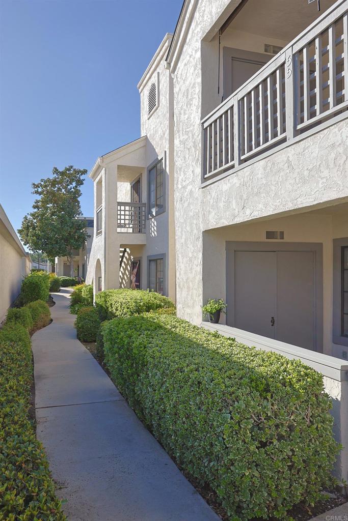 8612 Arminda Circle, Unit 51 Santee, CA 92071 - Photo 55 of 55 a front view of a house with a yard and garage