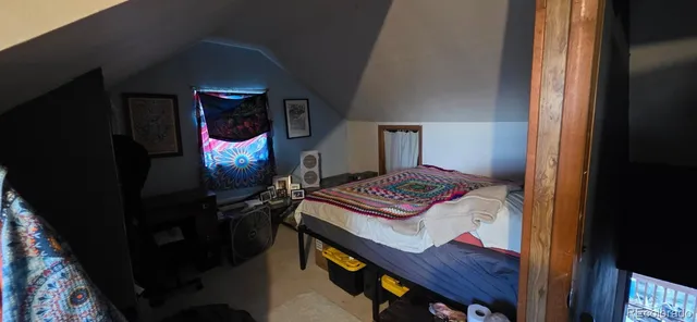 a bedroom with a bed and a lamp on table