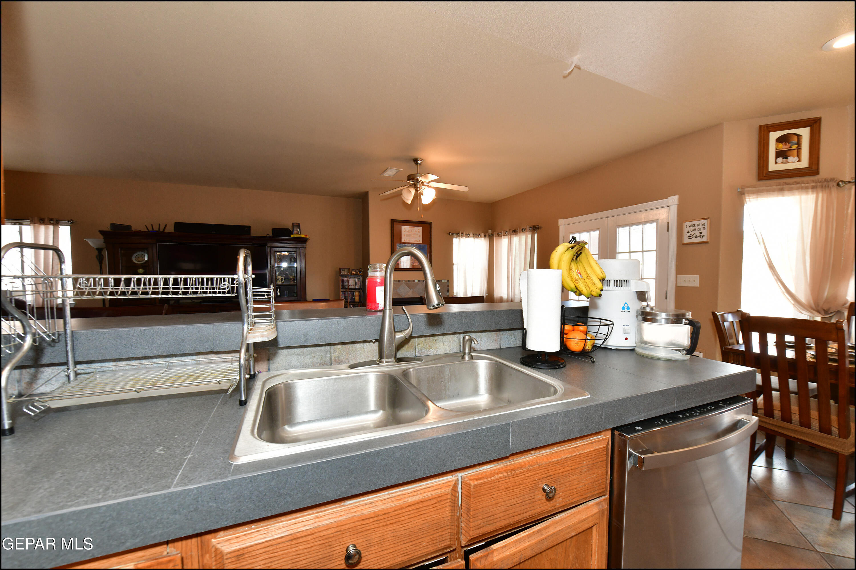 7350 Navidad Way Canutillo, TX 79835 - Photo 14 of 49 a sink with granite countertop a couch and a view of living room