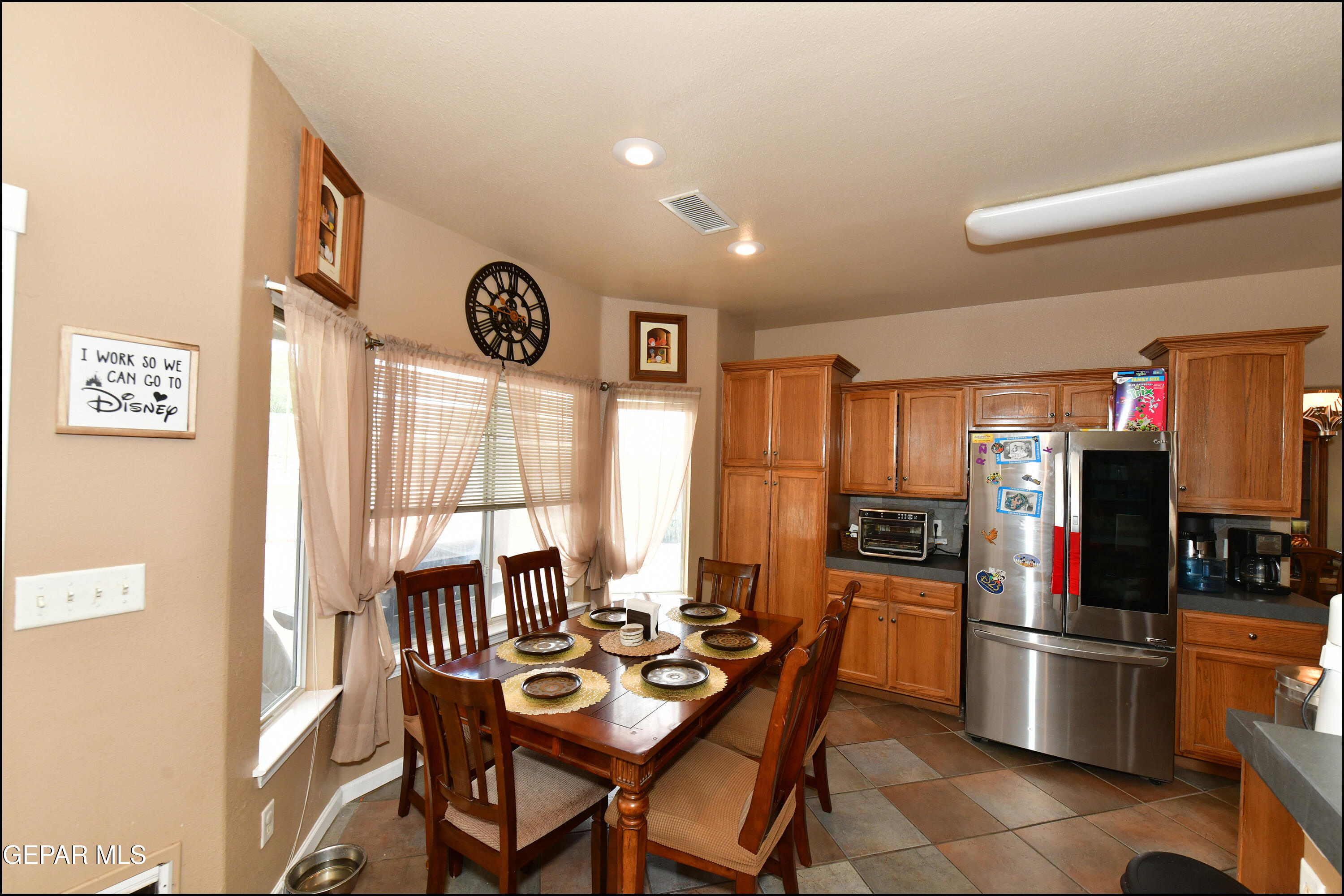 7350 Navidad Way Canutillo, TX 79835 - Photo 18 of 49 a dining room with stainless steel appliances kitchen island granite countertop a refrigerator a stove a dining table and chairs with wooden floor