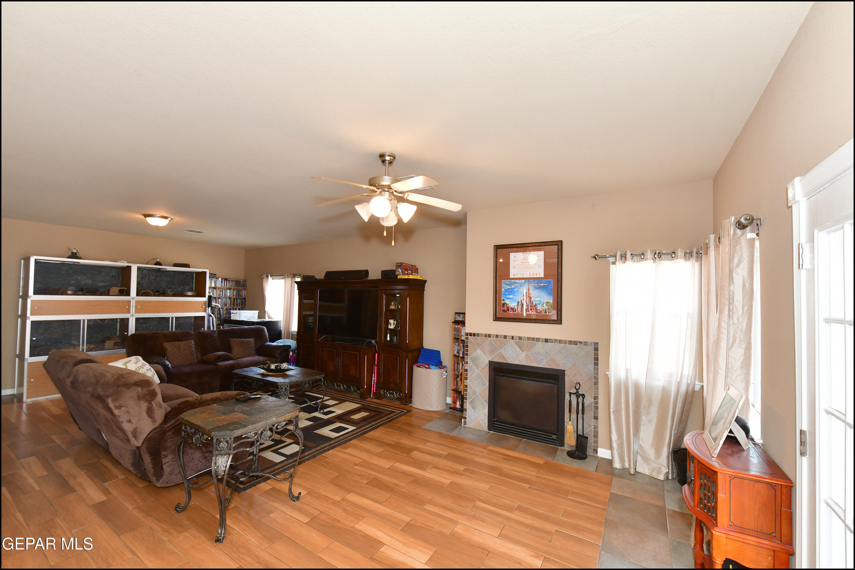 7350 Navidad Way Canutillo, TX 79835 - Photo 19 of 49 a living room with furniture a fireplace and a flat screen tv